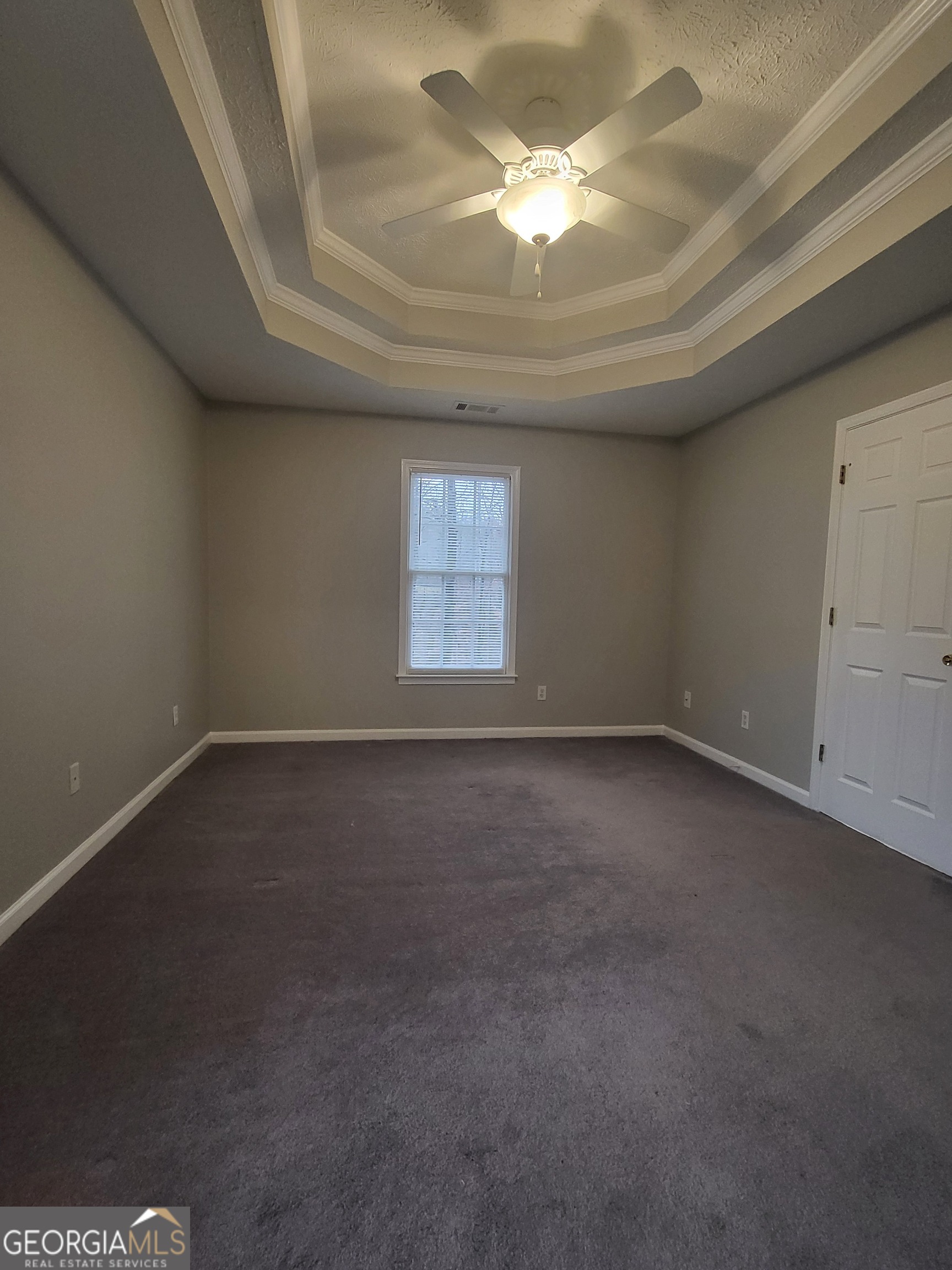 112 Sundown Drive Dawsonville, GA 30534 - Photo 14 of 25 an empty room with a chandelier fan and windows