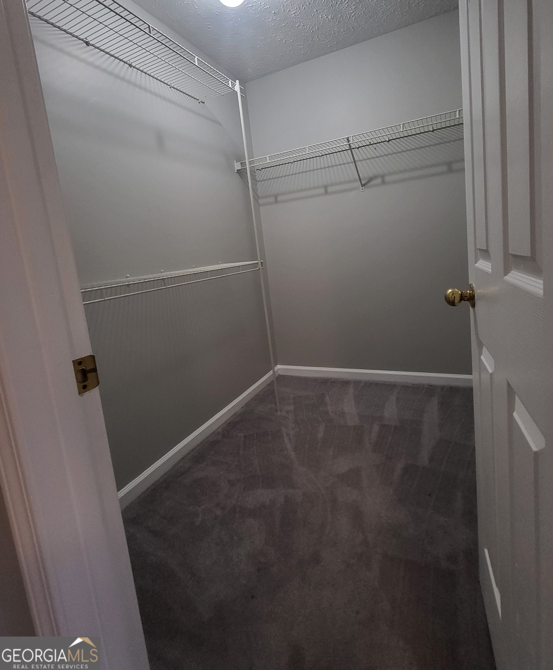 112 Sundown Drive Dawsonville, GA 30534 - Photo 18 of 25 a view of a room with racks on the wall