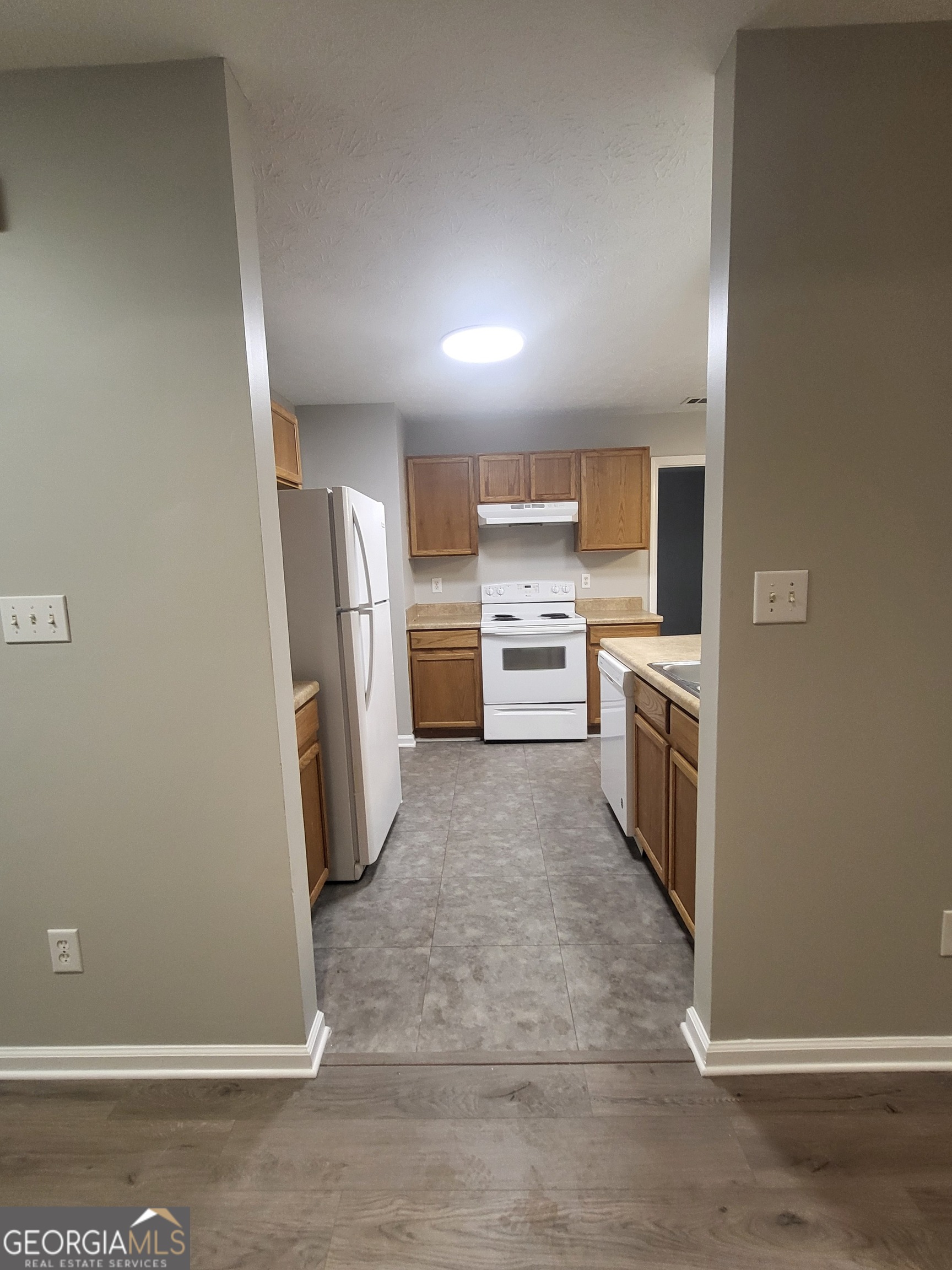 112 Sundown Drive Dawsonville, GA 30534 - Photo 6 of 25 a kitchen with a refrigerator and a sink