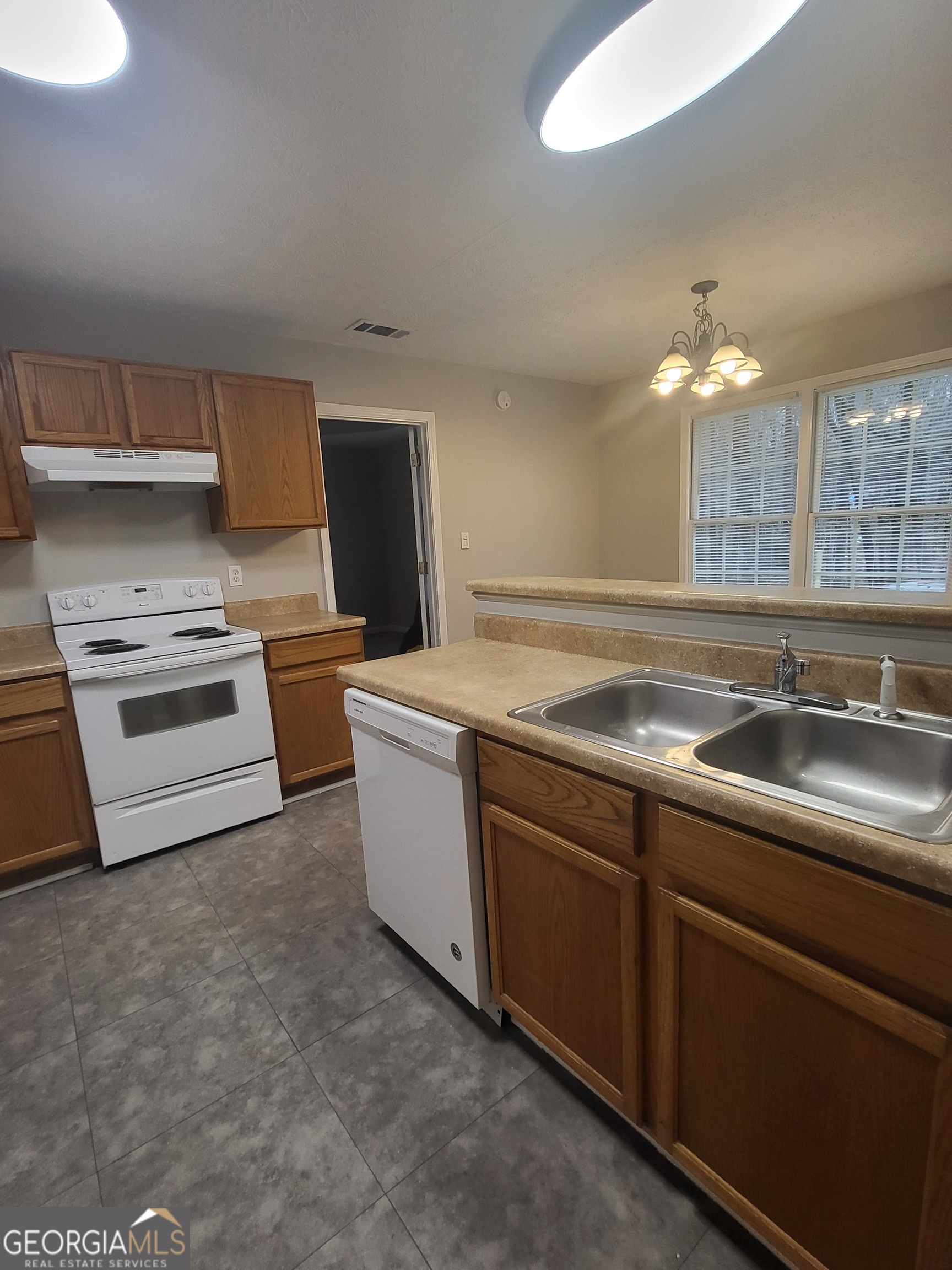 112 Sundown Drive Dawsonville, GA 30534 - Photo 7 of 25 a kitchen with stainless steel appliances a sink and a stove