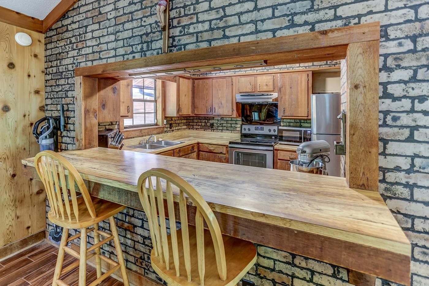 470 Metro Road Eads, TN 38028 - Photo 22 of 40 a kitchen with stainless steel appliances kitchen island granite countertop a stove a sink and a microwave