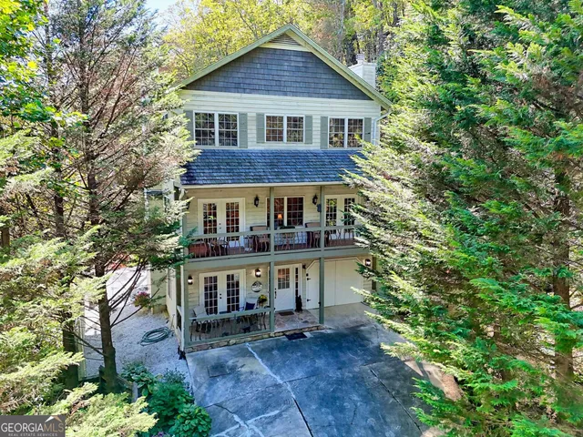 a view of a lush green field with a tree