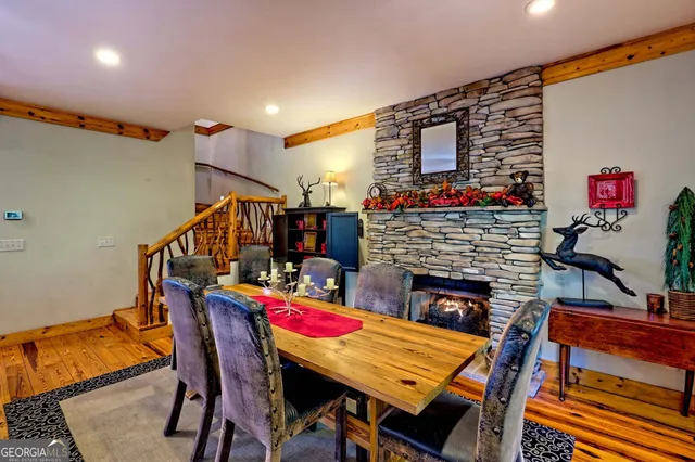 a kitchen with stainless steel appliances granite countertop a table chairs and a refrigerator