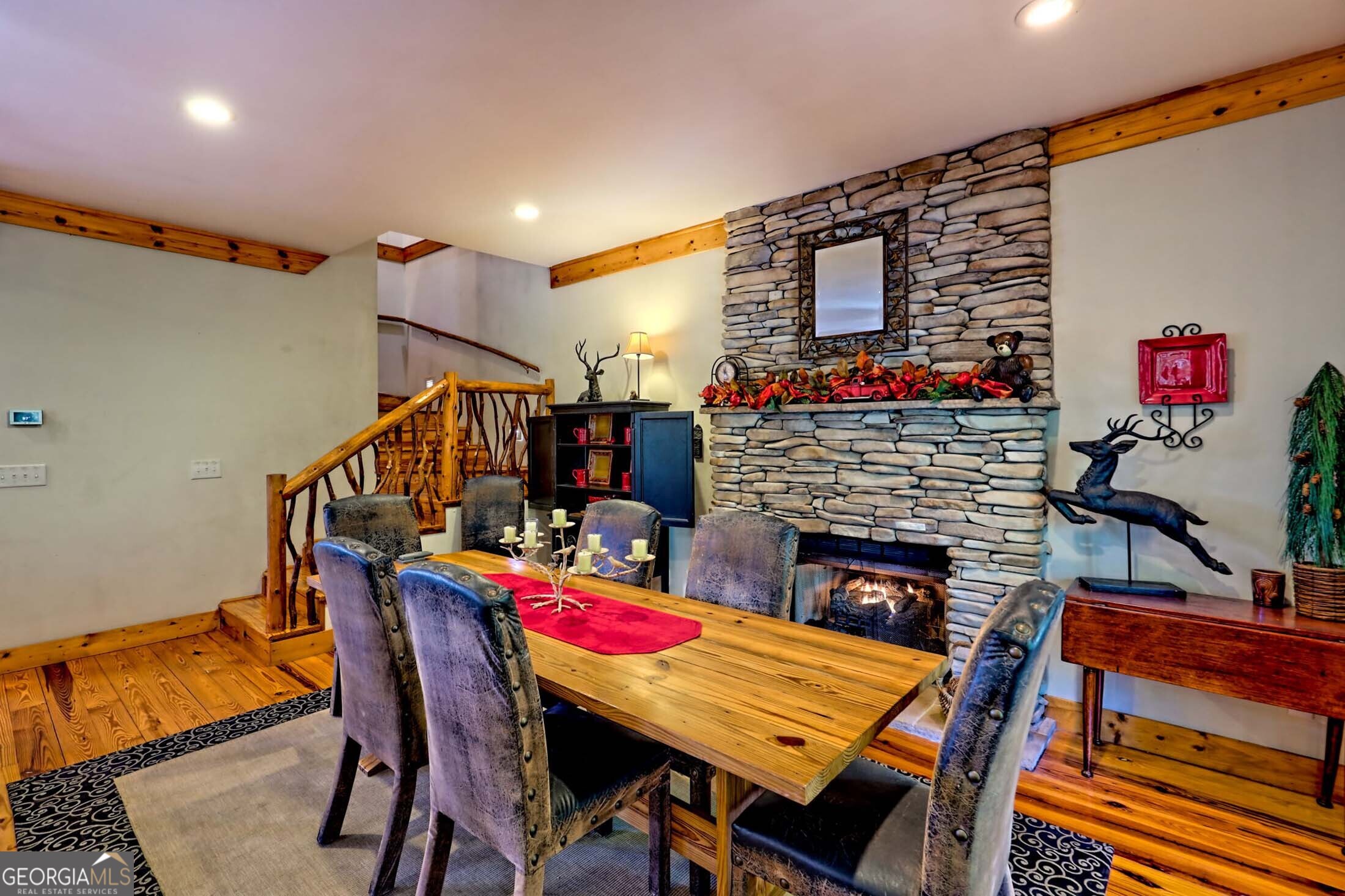 3315 Bald Mountain Road Dillard, GA 30537 - Photo 14 of 79 a dining room with furniture a rug and a fireplace