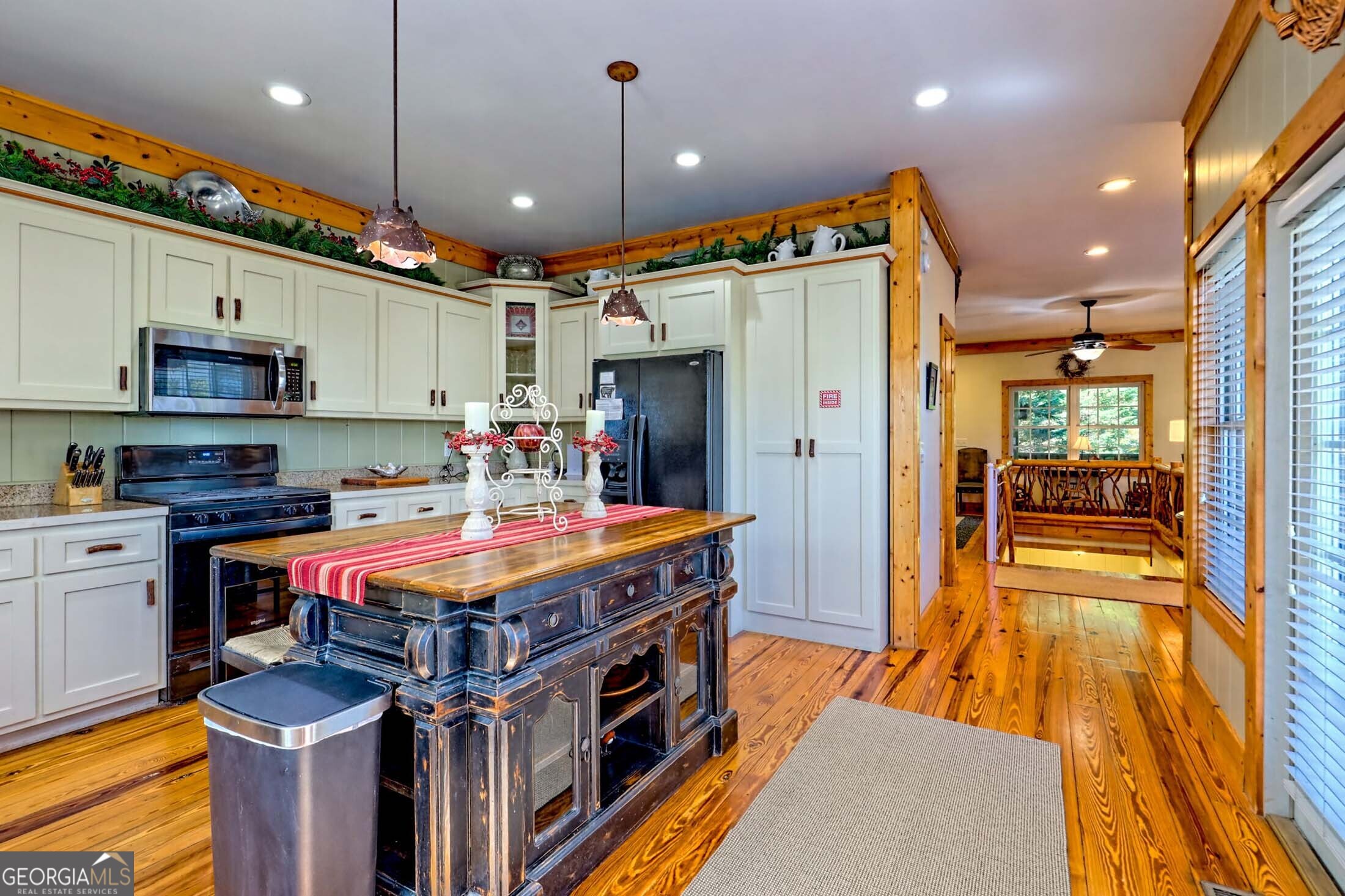 3315 Bald Mountain Road Dillard, GA 30537 - Photo 26 of 79 a kitchen with stainless steel appliances granite countertop a table chairs and a refrigerator