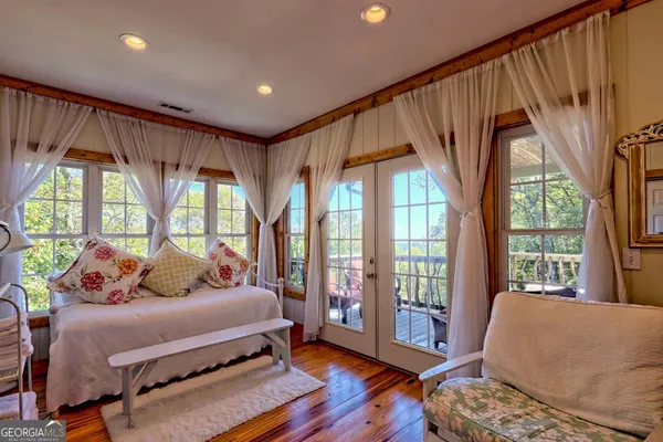 a bedroom with furniture and a flat screen tv