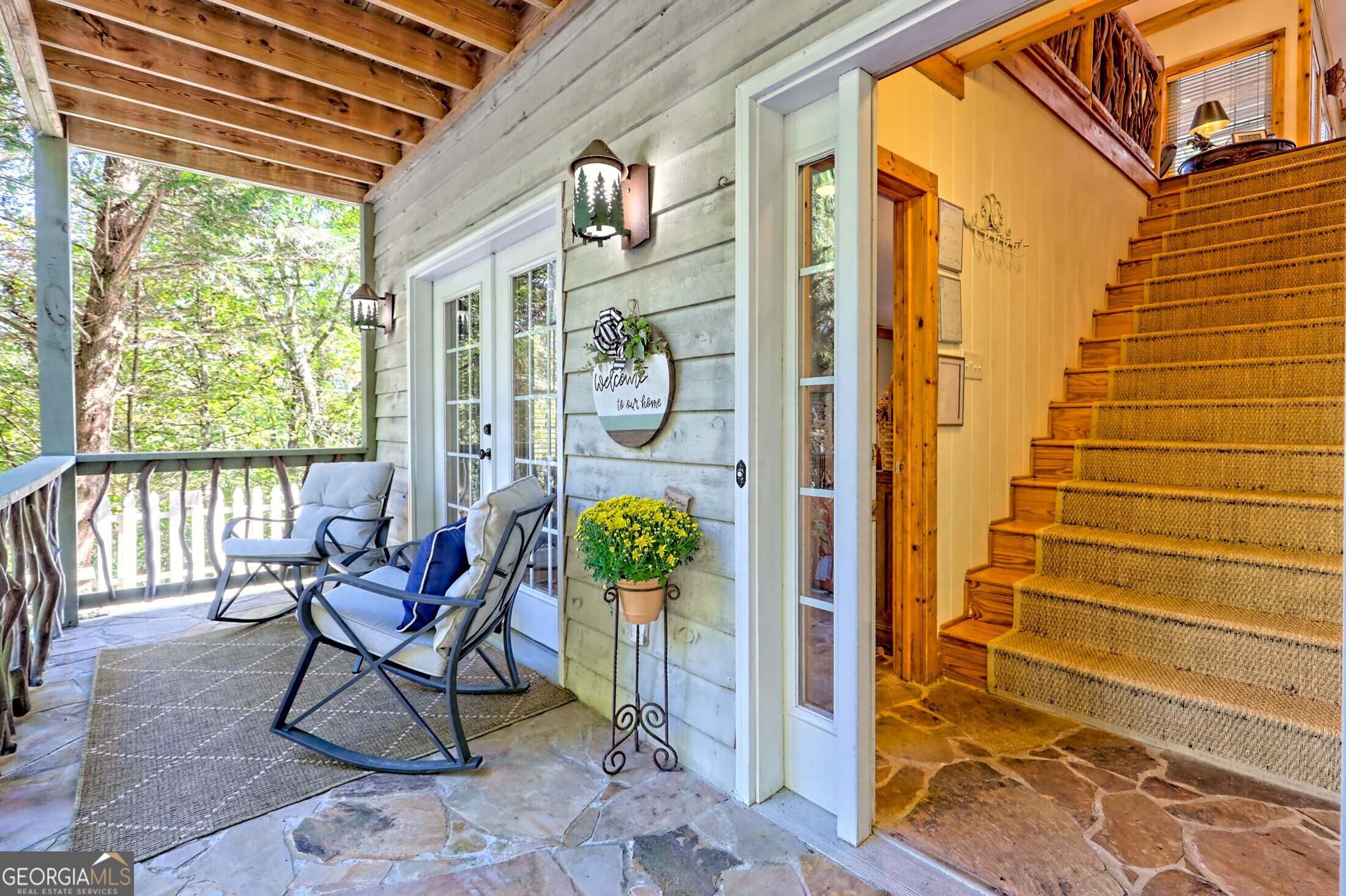 3315 Bald Mountain Road Dillard, GA 30537 - Photo 4 of 79 a view of a patio with a table and chairs and wooden floor