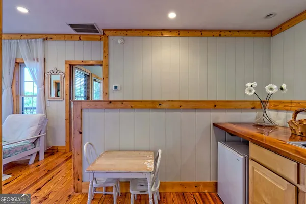 a view of a lush green field with mountains in the background