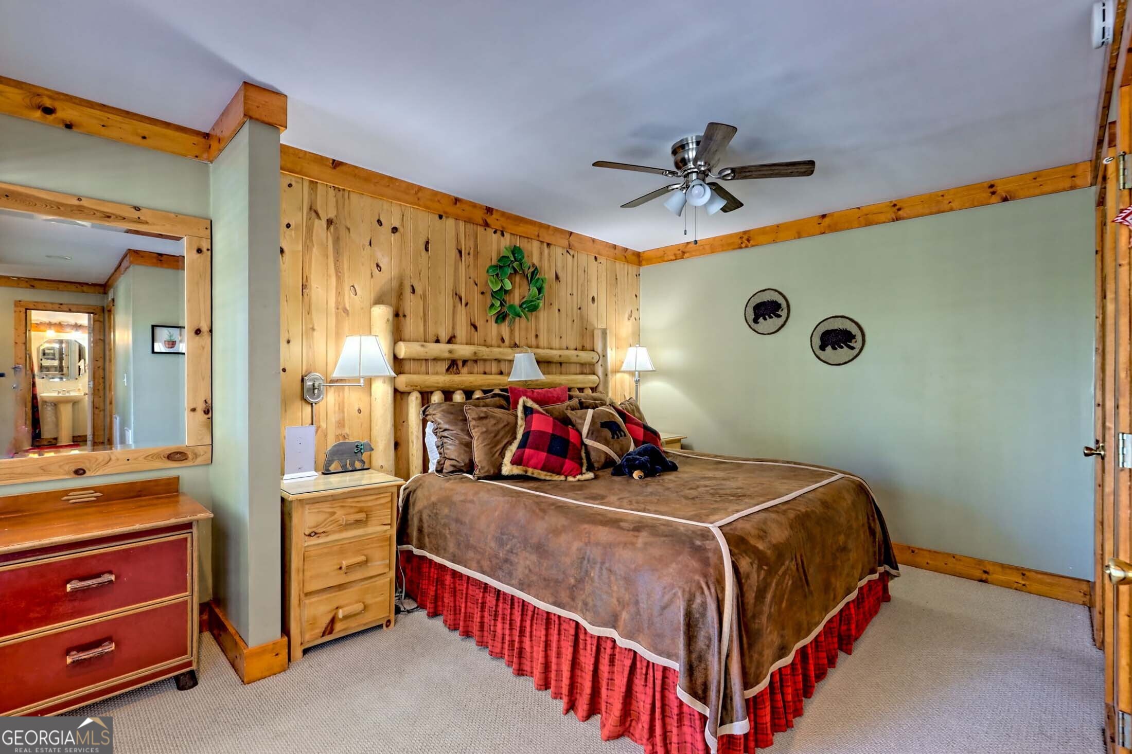 3315 Bald Mountain Road Dillard, GA 30537 - Photo 64 of 79 a bedroom with a bed and a chandelier