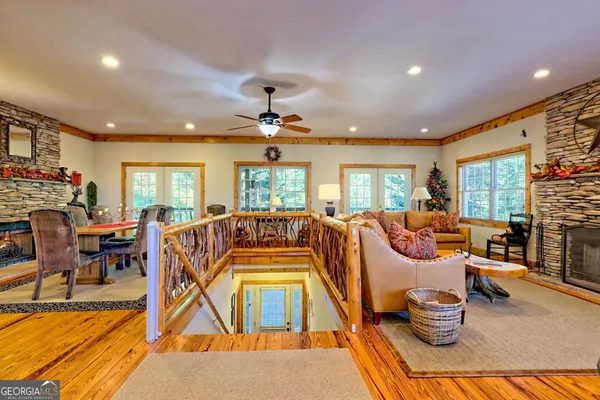 a living room with fireplace furniture and a large window