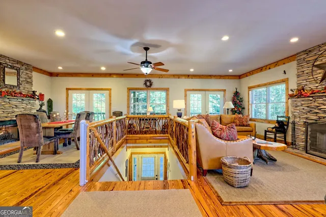 a living room with fireplace furniture and a large window