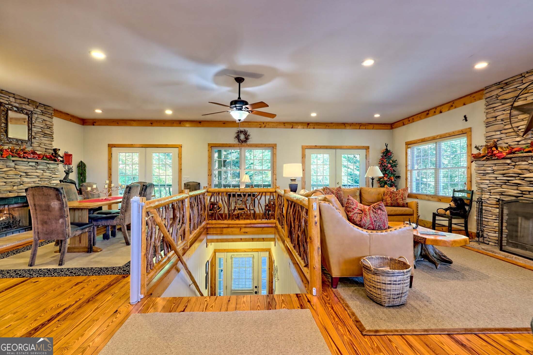 3315 Bald Mountain Road Dillard, GA 30537 - Photo 7 of 79 a living room with furniture a fireplace and a dining table