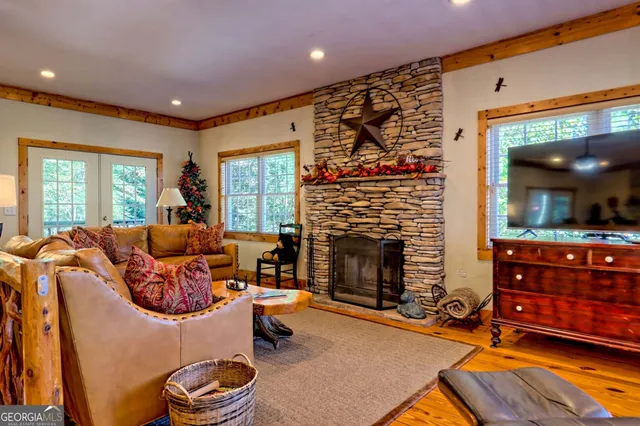 a living room with furniture ceiling fan and a large window