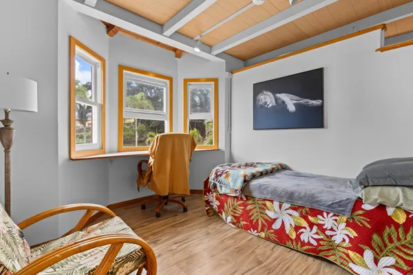 a bed sitting in a bedroom next to a window