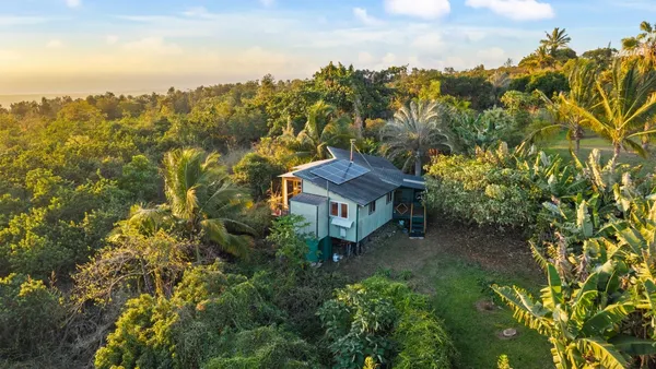 an aerial view of a house with a yard basket ball court and outdoor seating