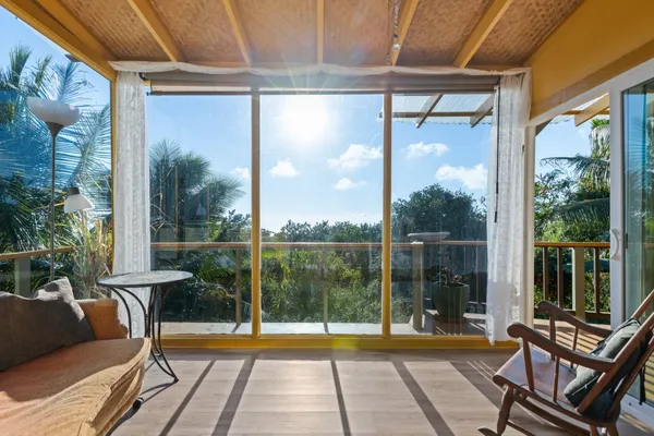a view of a two chairs in the balcony