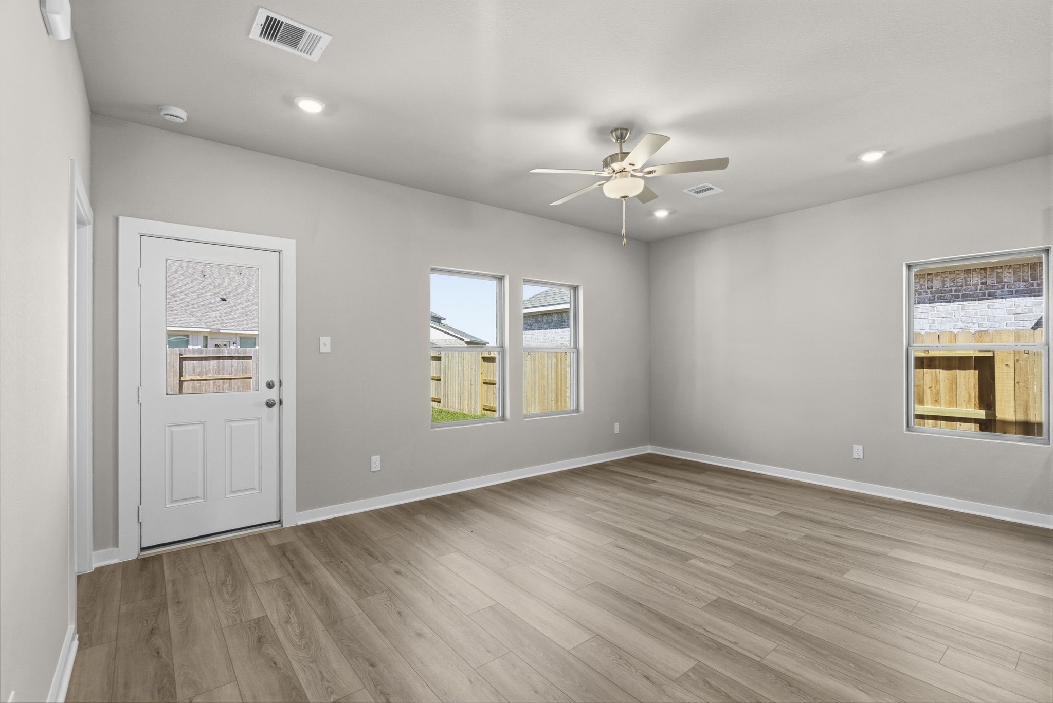 3627 Atlas Pt Lane Angleton, TX 77515 - Photo 11 of 36 wooden floor in an empty room with a window