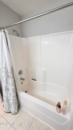 a bathroom with a shower and a bath tub