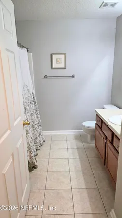 a bathroom with a sink a toilet and a shower