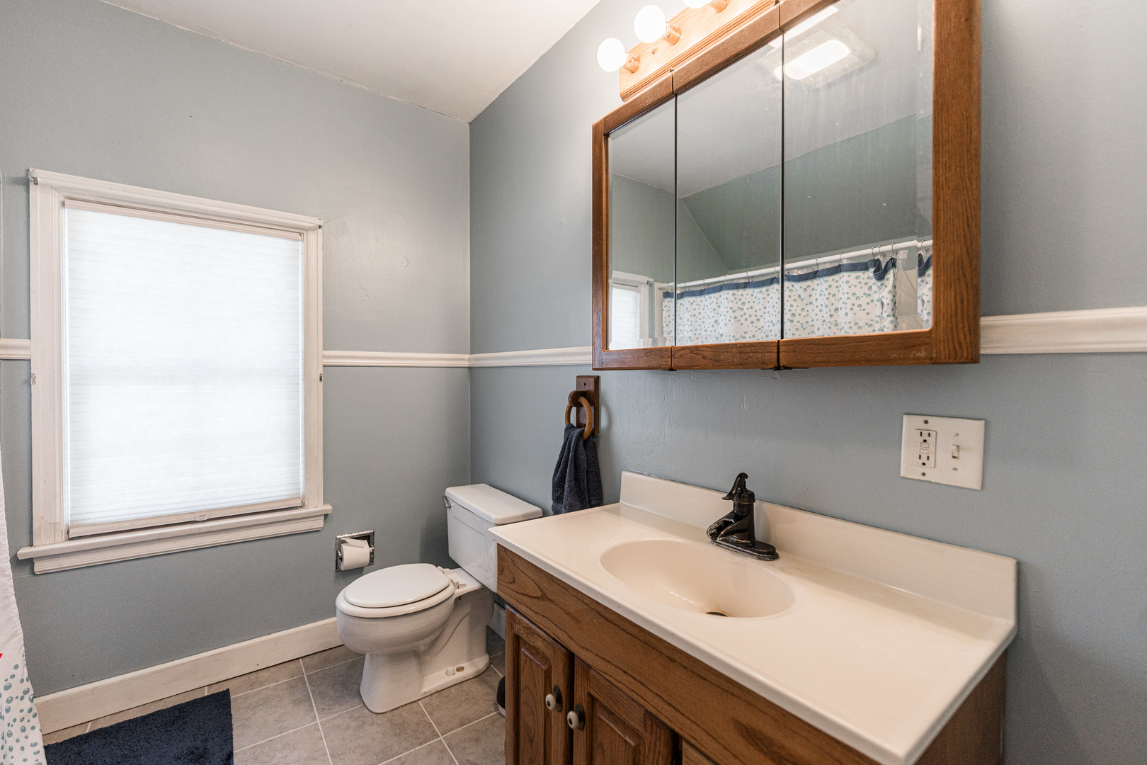 1020 North 8th Street Rochelle, IL 61068 - Photo 18 of 21 a bathroom with a sink a toilet and a mirror