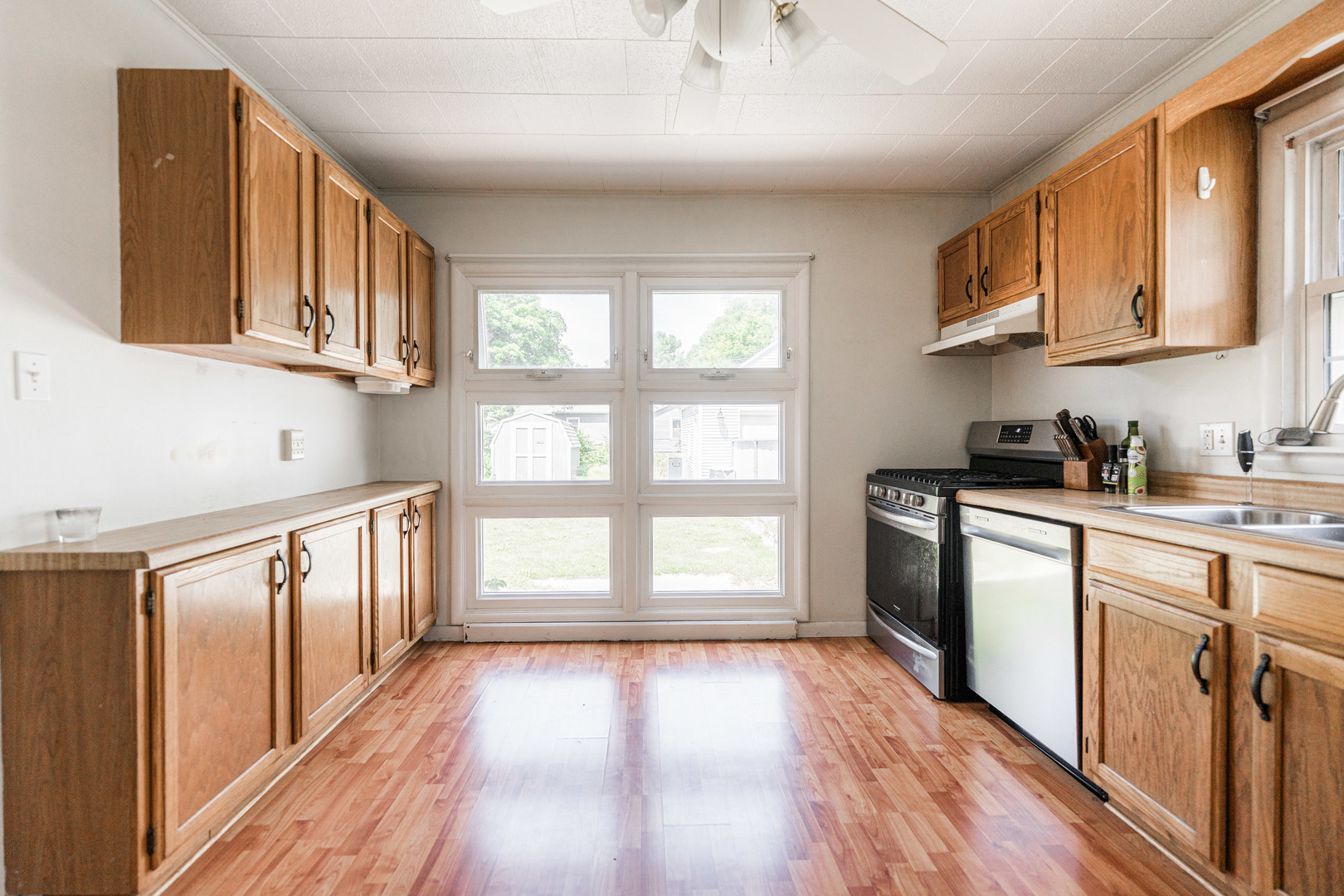 1020 North 8th Street Rochelle, IL 61068 - Photo 7 of 21 a kitchen with stainless steel appliances granite countertop a refrigerator a stove top oven a sink and dishwasher with wooden floor