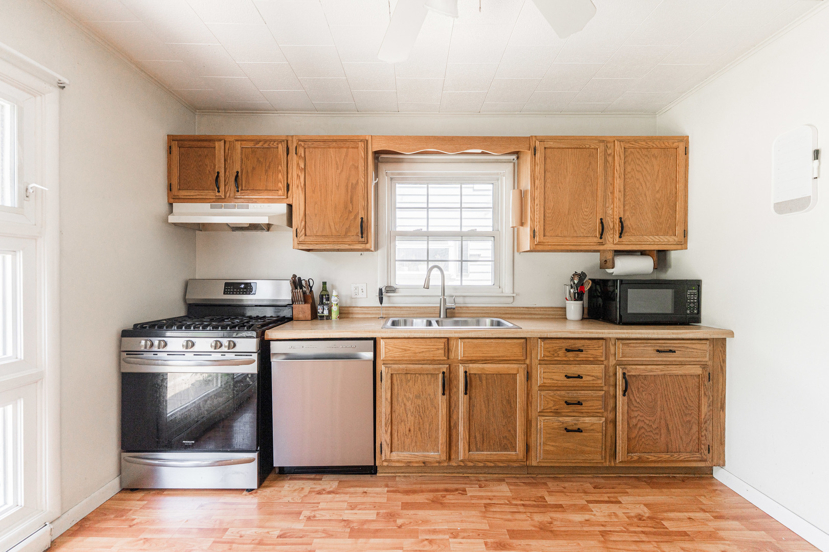 1020 North 8th Street Rochelle, IL 61068 - Photo 8 of 21 a kitchen with stainless steel appliances granite countertop a stove a sink and a microwave