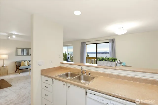 a kitchen with a sink and large window
