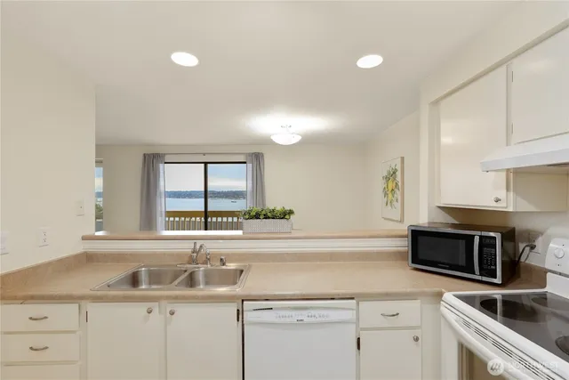 a kitchen with a sink cabinets and window