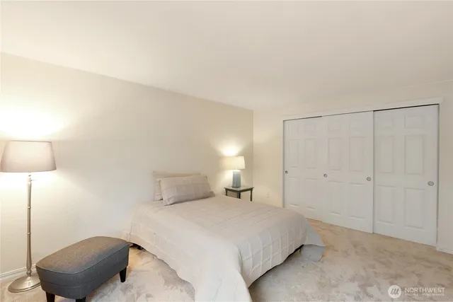 a bedroom with a bed and a lamp