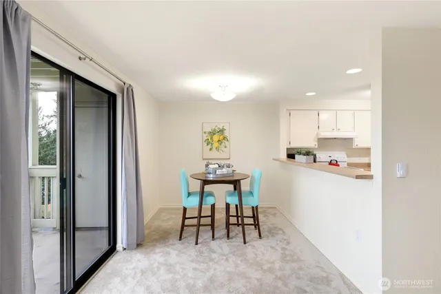 a view of kitchen with kitchen island dining table and chairs