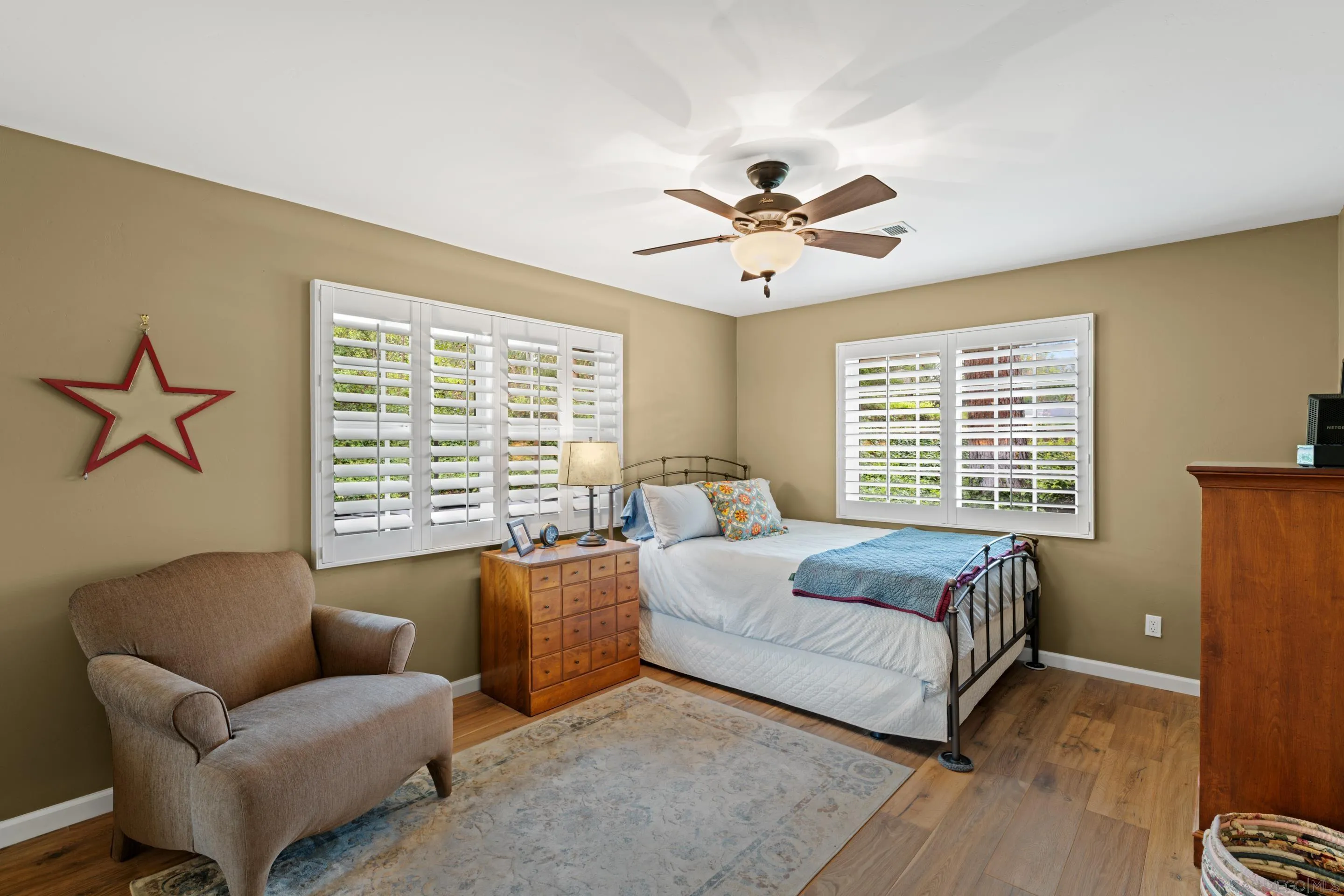 16327 Woodson View Road Poway, CA 92064 - Photo 28 of 54 a bedroom with a large bed couch and a window