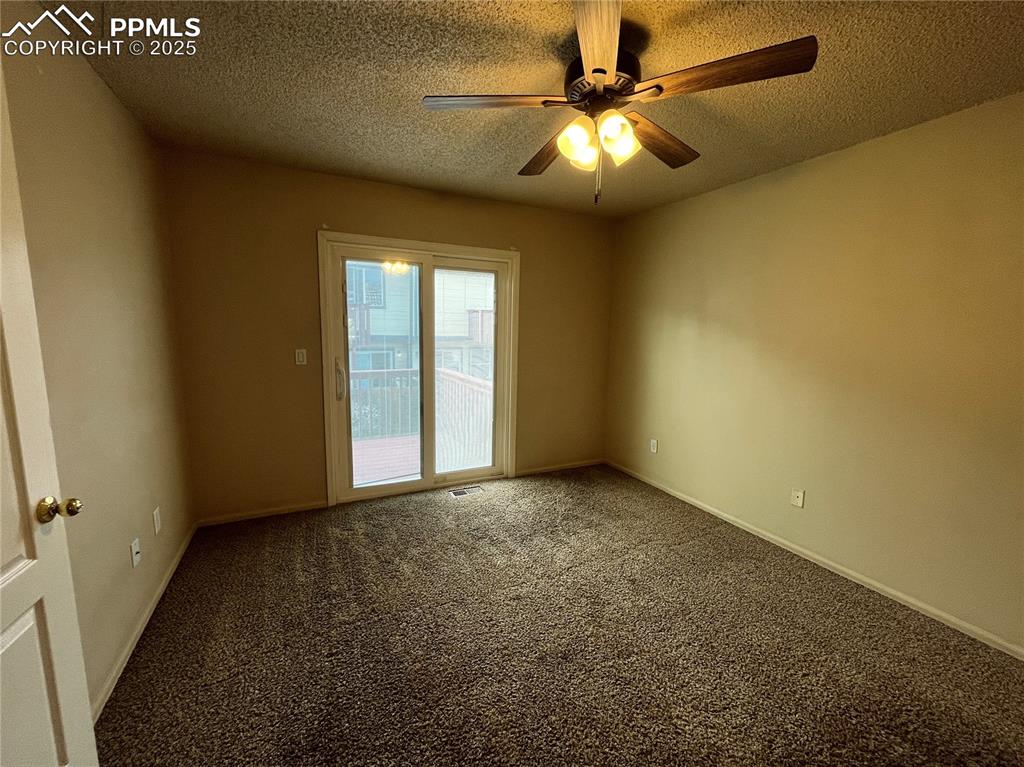 718 Mediterranean Point Colorado Springs, CO 80910 - Photo 11 of 28 an empty room with windows and fan