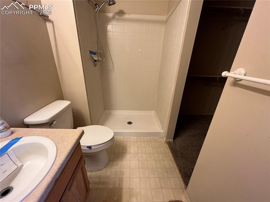 718 Mediterranean Point Colorado Springs, CO 80910 - Photo 15 of 28 a white toilet sitting next to a bathroom sink and a tub