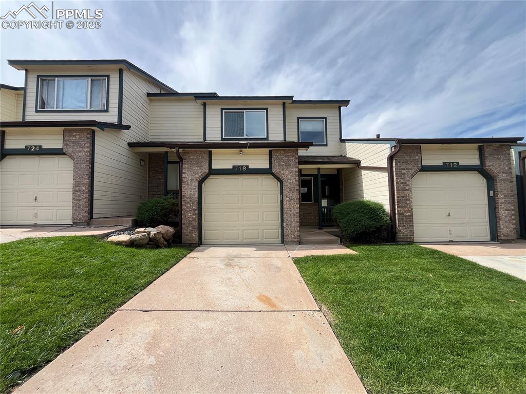 718 Mediterranean Point Colorado Springs, CO 80910 - Photo 3 of 28 a front view of a house with a yard and garage