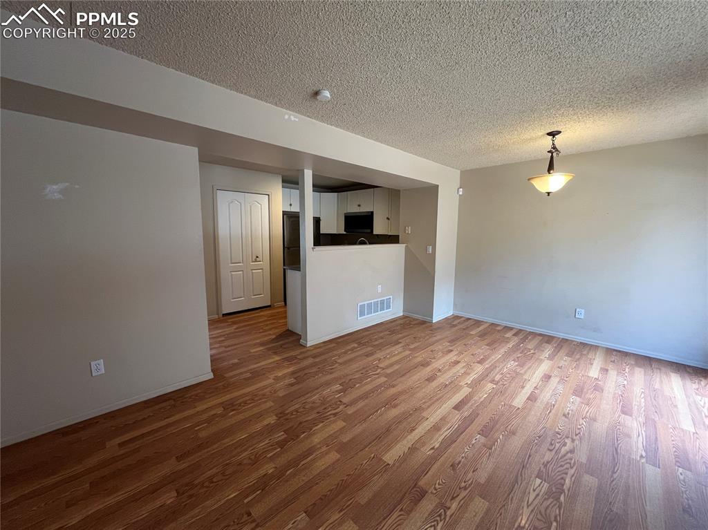718 Mediterranean Point Colorado Springs, CO 80910 - Photo 9 of 28 a view of empty room with wooden floor