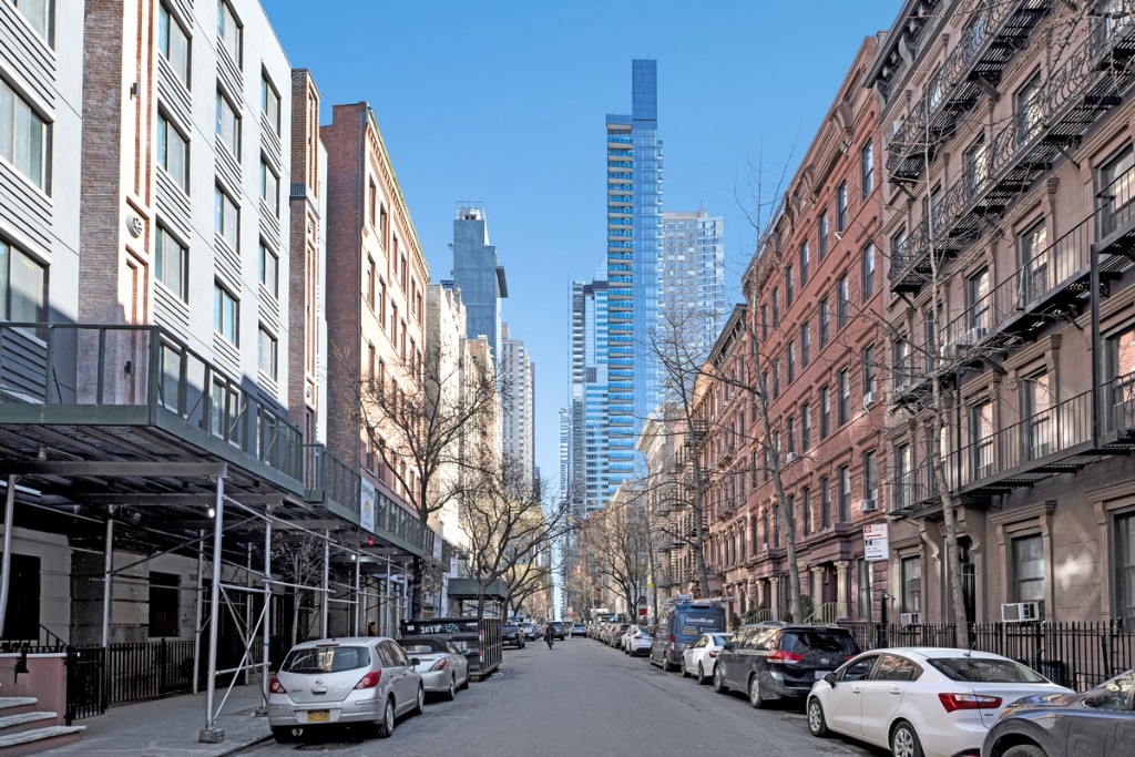 356 West 48th Street, Unit 2C Manhattan, NY 10036 - Photo 12 of 25 a city street lined with parked cars and buildings