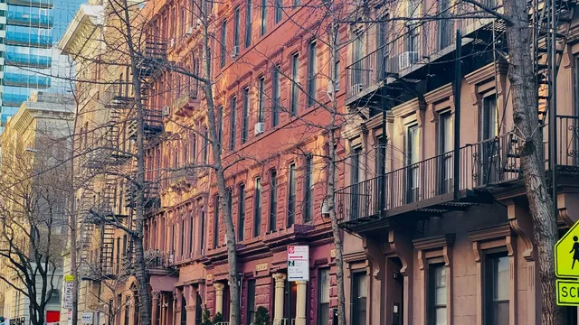 a view of street with a brick building and a fountain