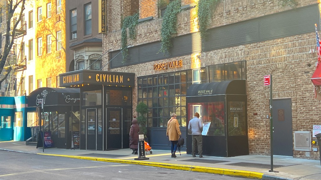 356 West 48th Street, Unit 2C Manhattan, NY 10036 - Photo 19 of 25 a view of street with a brick building and a fountain