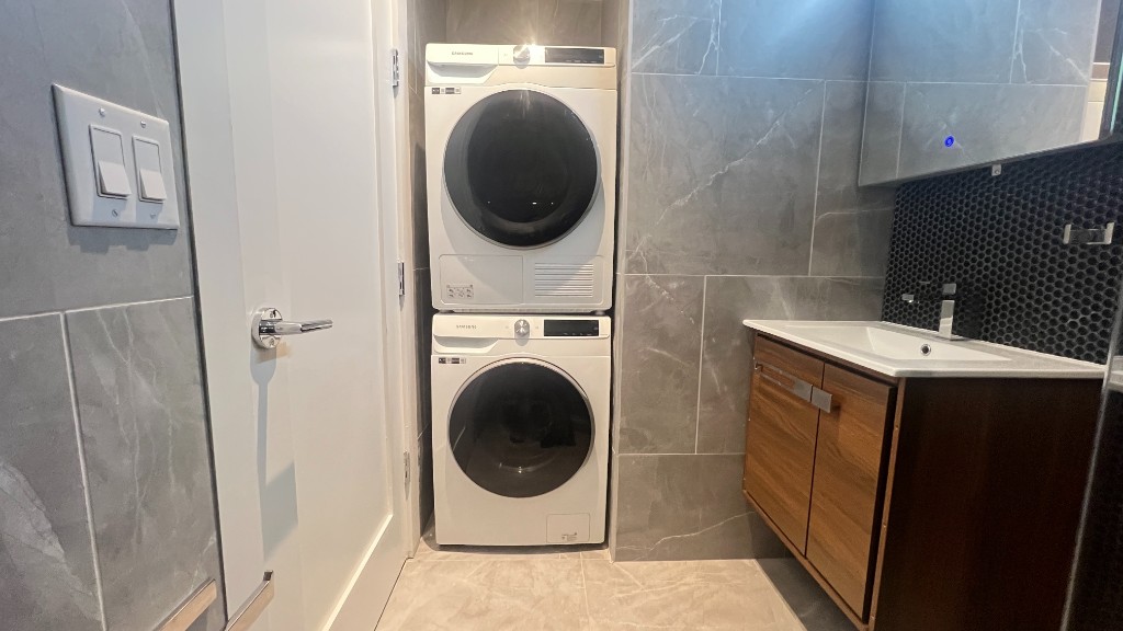 356 West 48th Street, Unit 2C Manhattan, NY 10036 - Photo 10 of 25 a utility room with dryer and washer