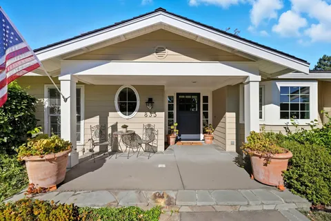 a front view of a house with outdoor seating and plants