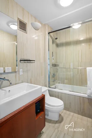 a bedroom with a bed couch and a large window