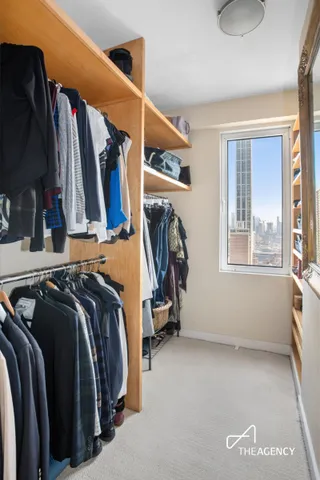 a spacious bedroom with a bed and large windows