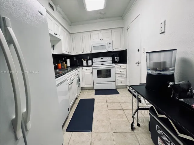 a kitchen with a stove a sink and a refrigerator
