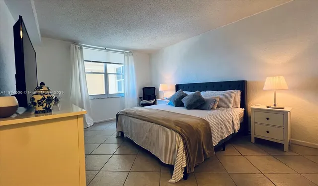 a bed room with a bed and a lamp