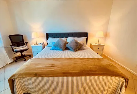 a bedroom with a bed and chair