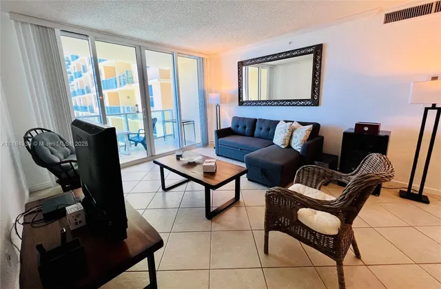 a living room with furniture and a floor to ceiling window