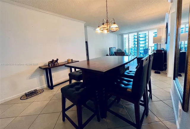a view of a dining room with furniture and chandelier
