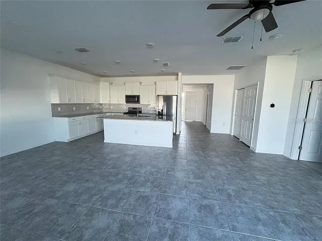 a kitchen with refrigerator and microwave
