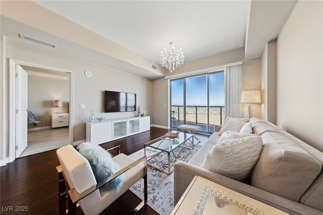 Living room with a chandelier and wood-type floori