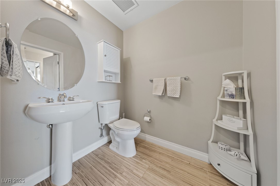 8255 South Las Vegas Boulevard, Unit 809 Las Vegas, NV 89123 - Photo 11 of 32 Bathroom featuring toilet and wood finished floors